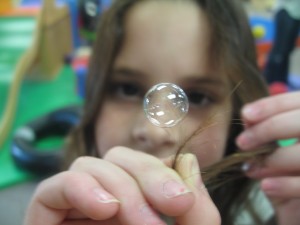 girl with bubble on hair