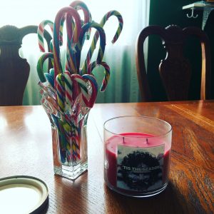 a candy cane pile and a christmas candle